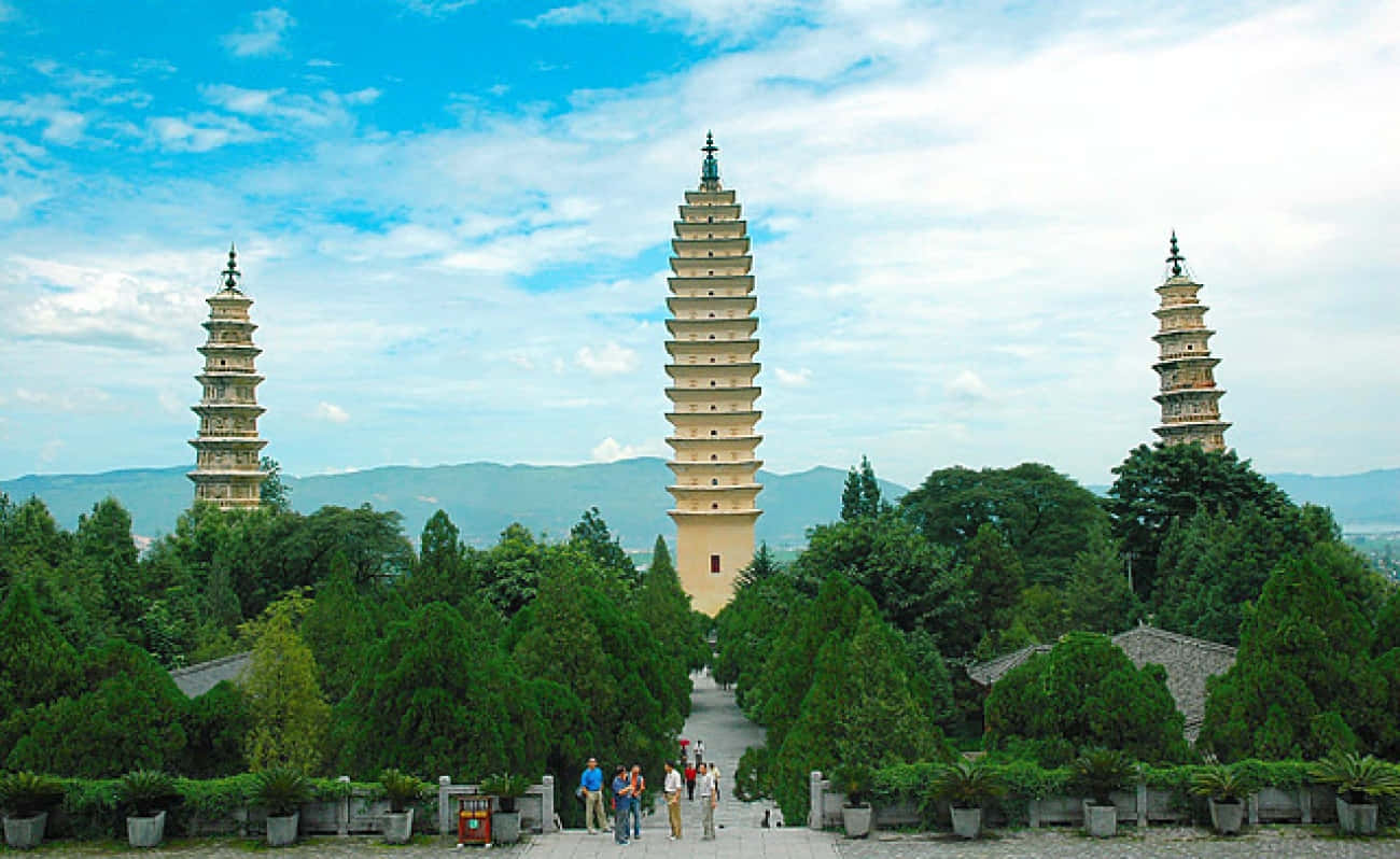 Three Pagodas With Tourists Background