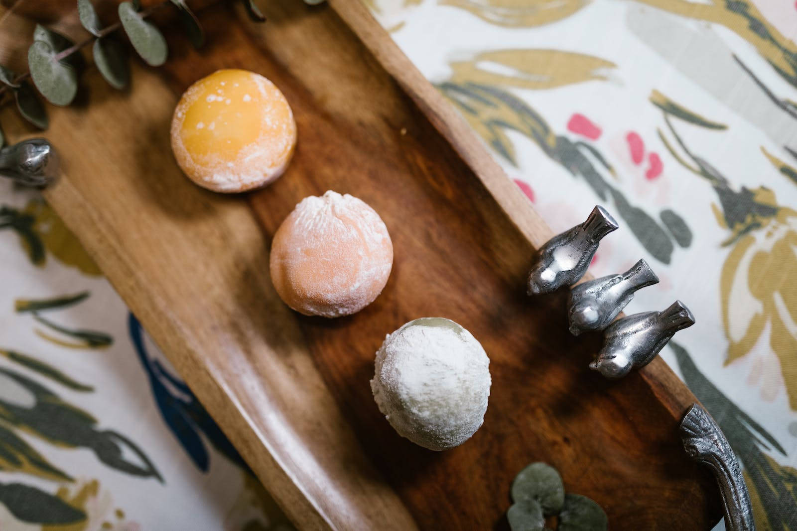 Three Pieces Of Mochi On A Wooden Tray Background