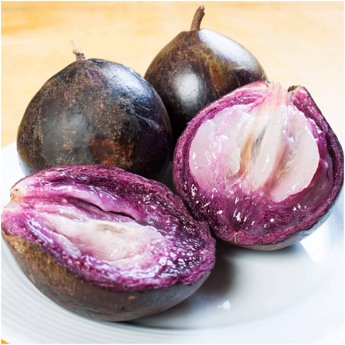 Three Purple Star Apples In Plate Background