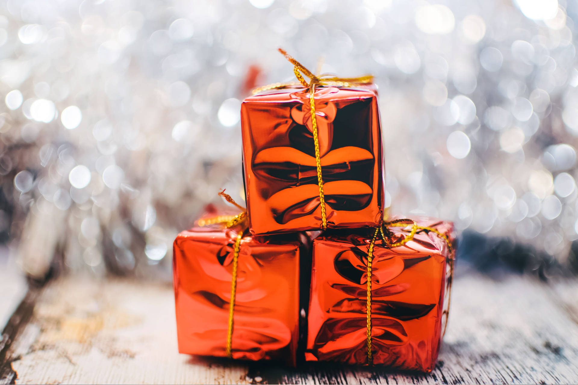 Three Red Gift Boxes On A Wooden Table Background