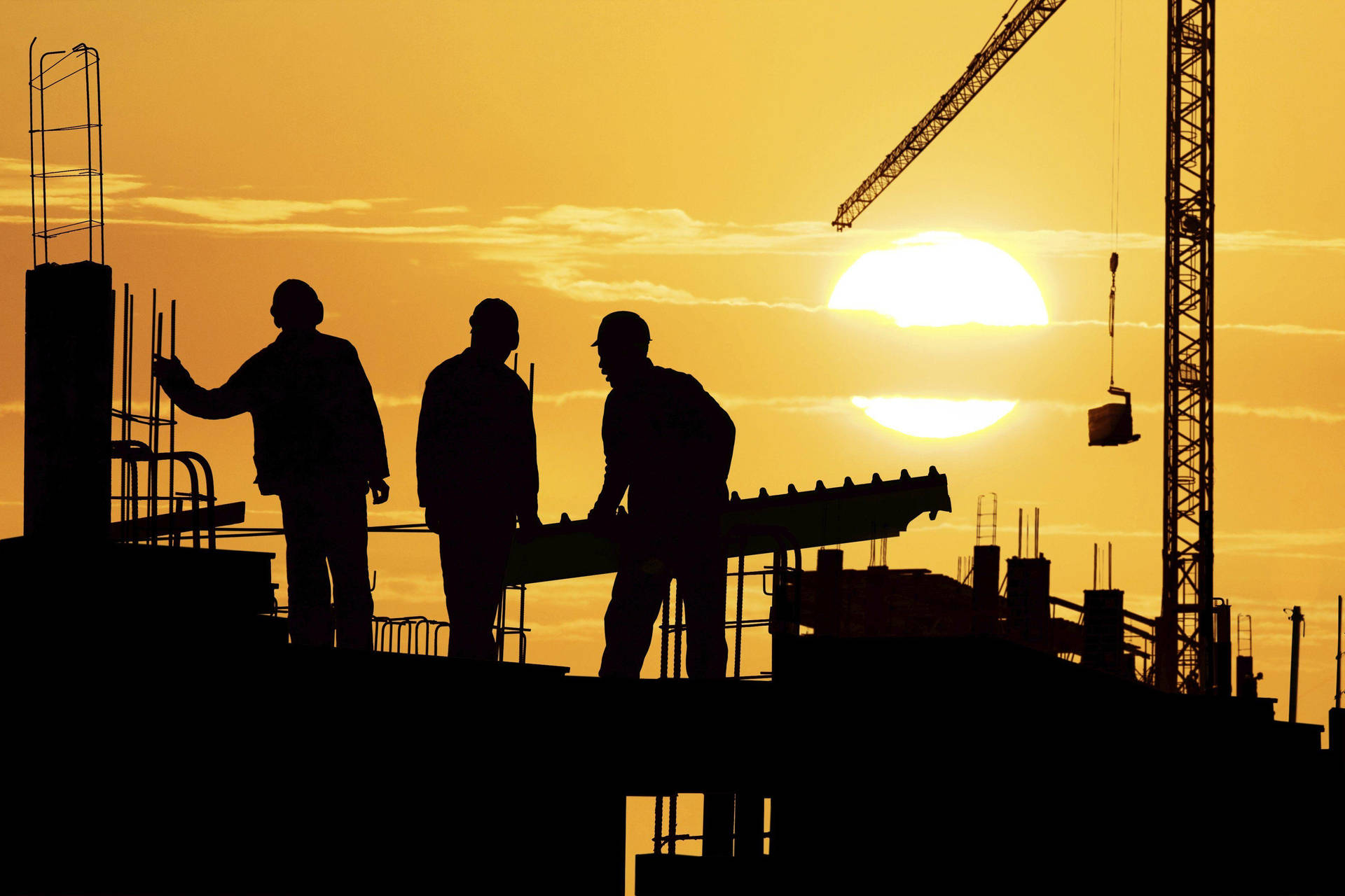 Three Silhouetted Construction Workers Background