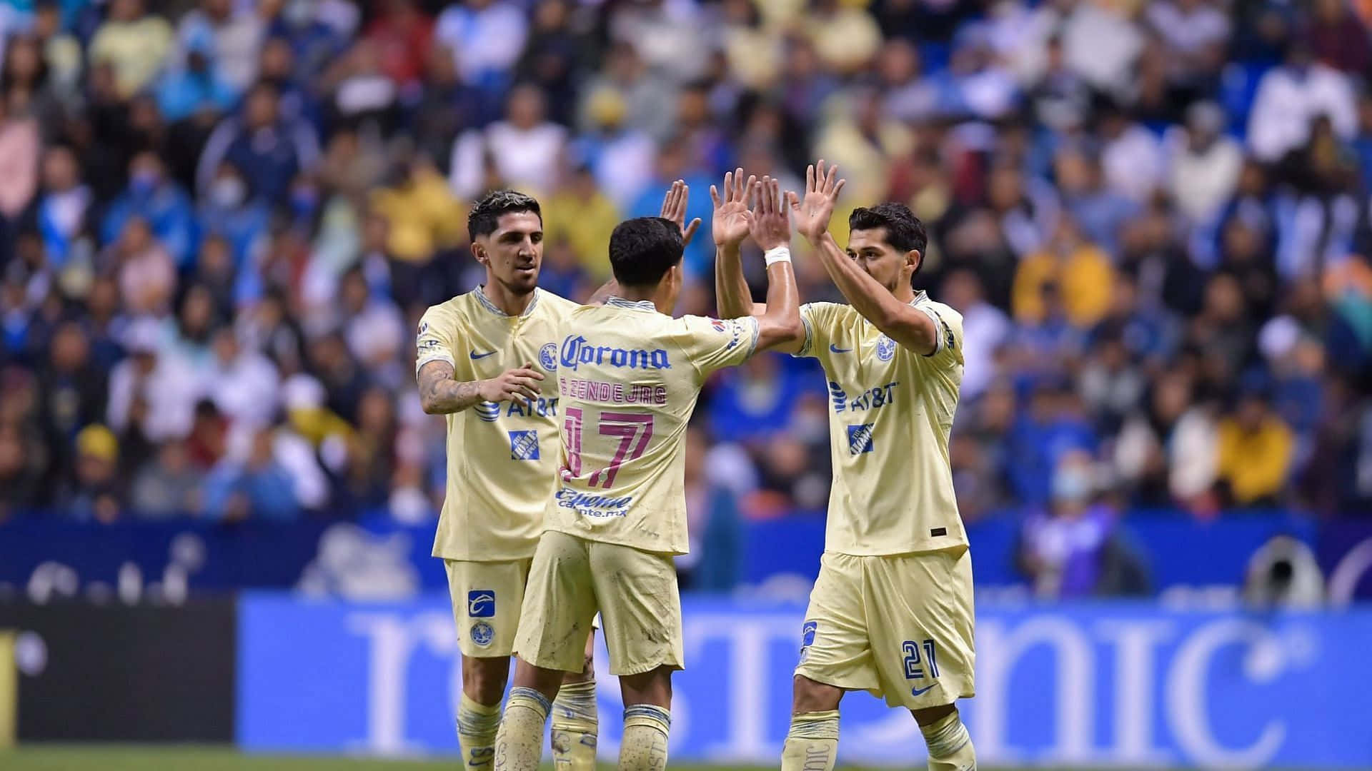 Three Soccer Players High Five Each Other During A Game Background