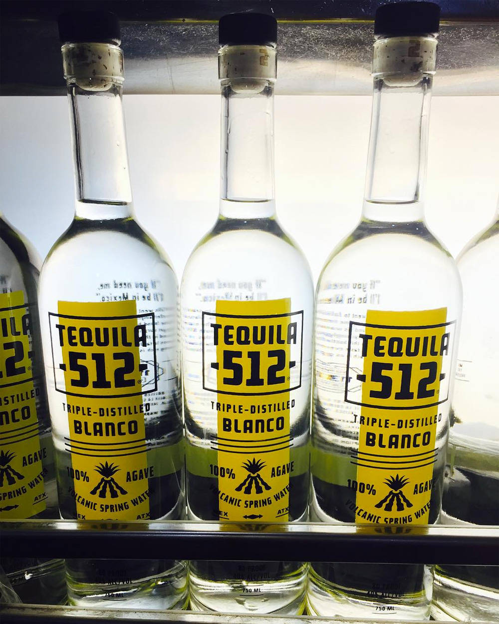 Three Tequila 512 Blanco Bottles Background