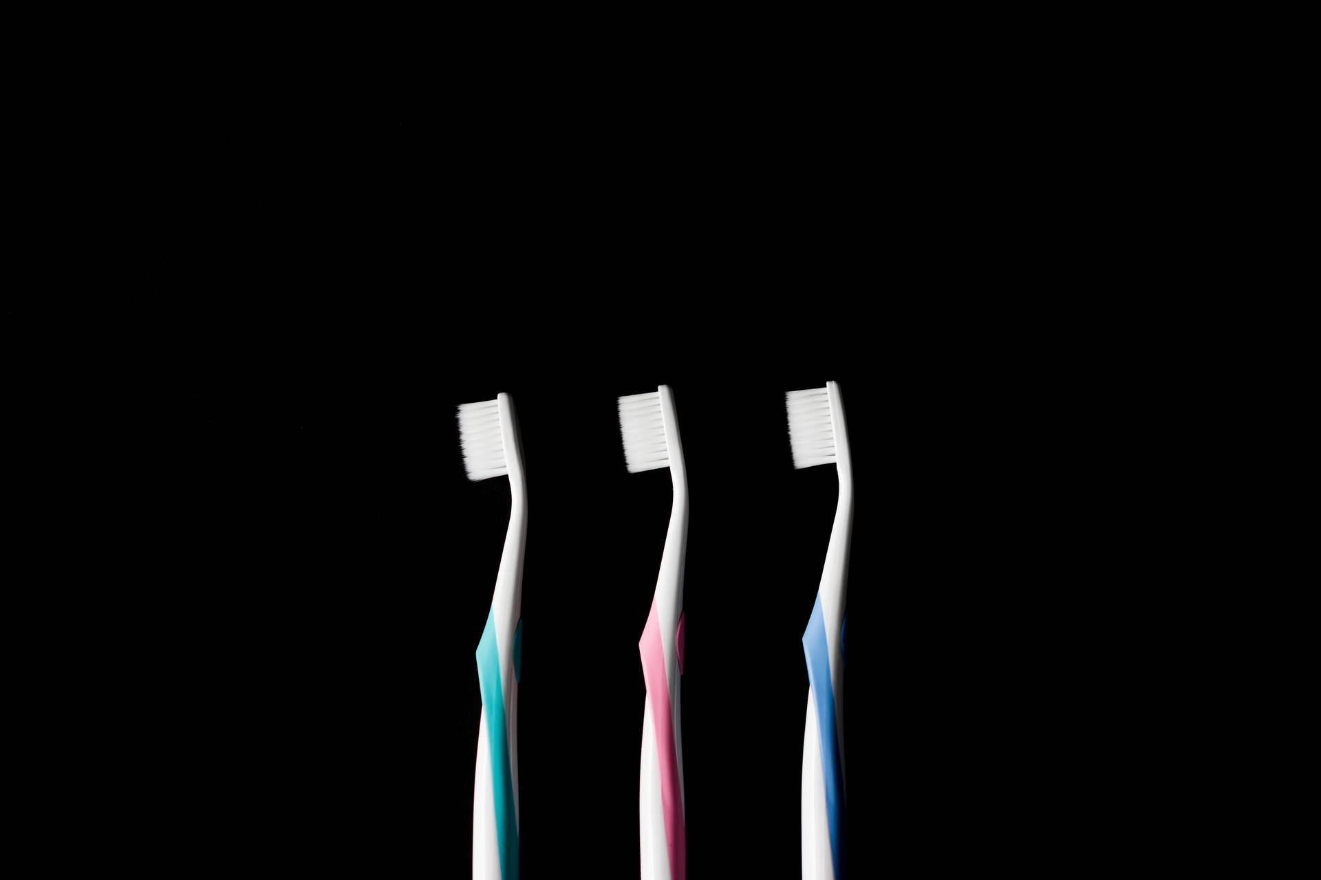 Three Toothbrushes Dentistry Background