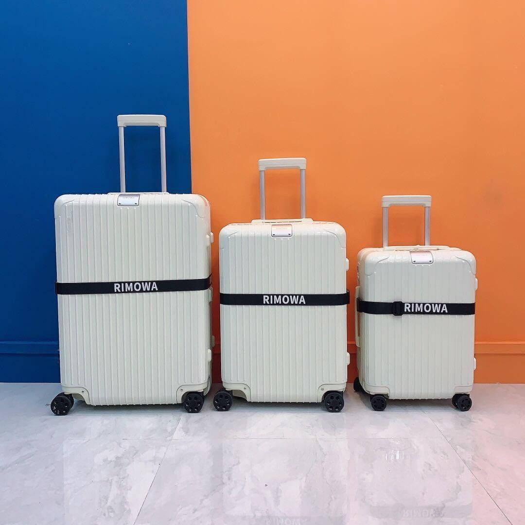 Three White Rimowa Suitcases