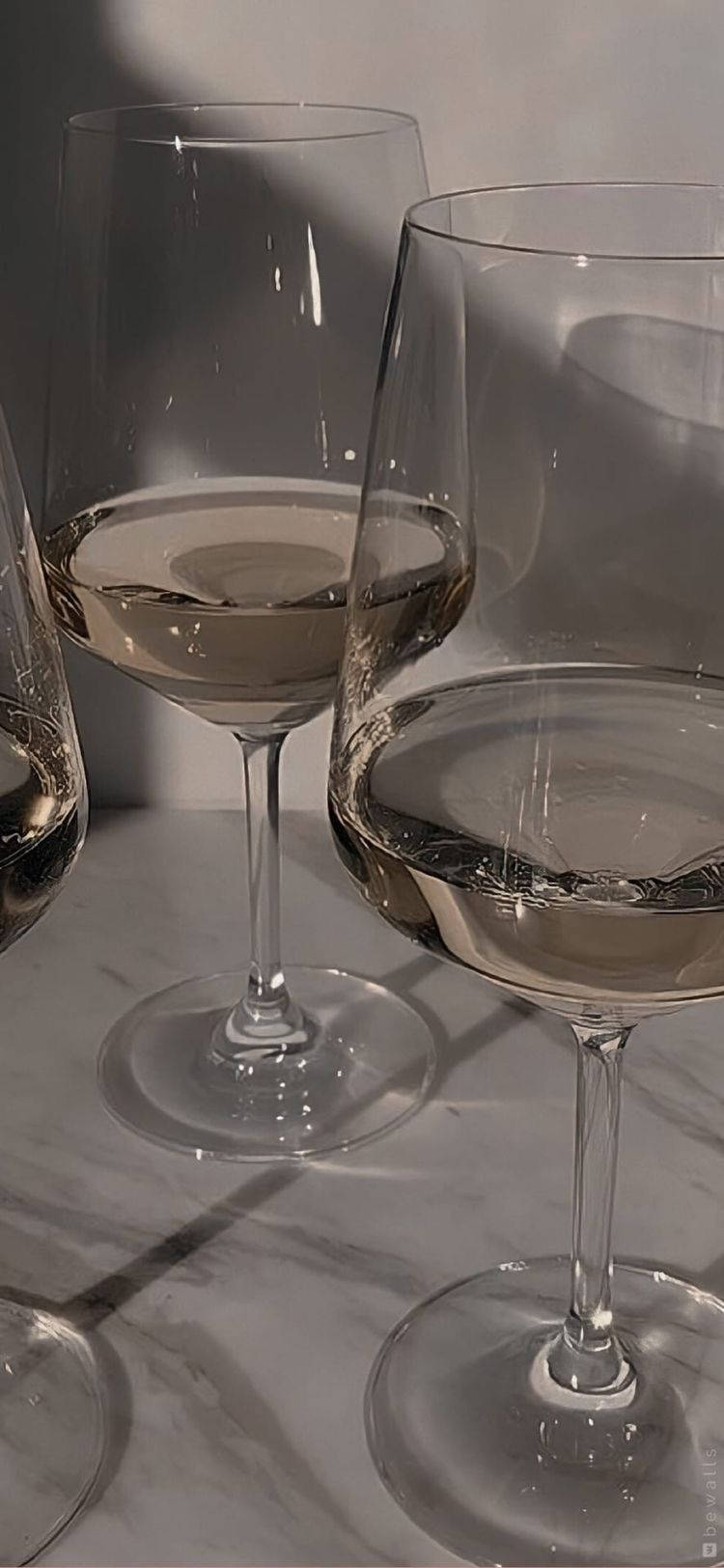 Three Wine Glasses On A Marble Surface Background