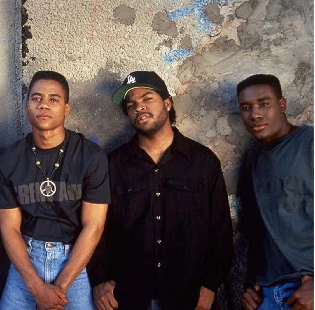 Three Young Men Standing Next To A Wall Background