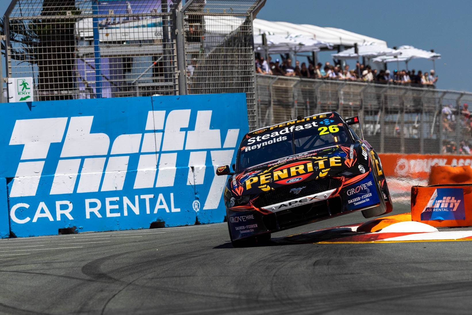 Thrifty Car Rental Logo On Race Track Background