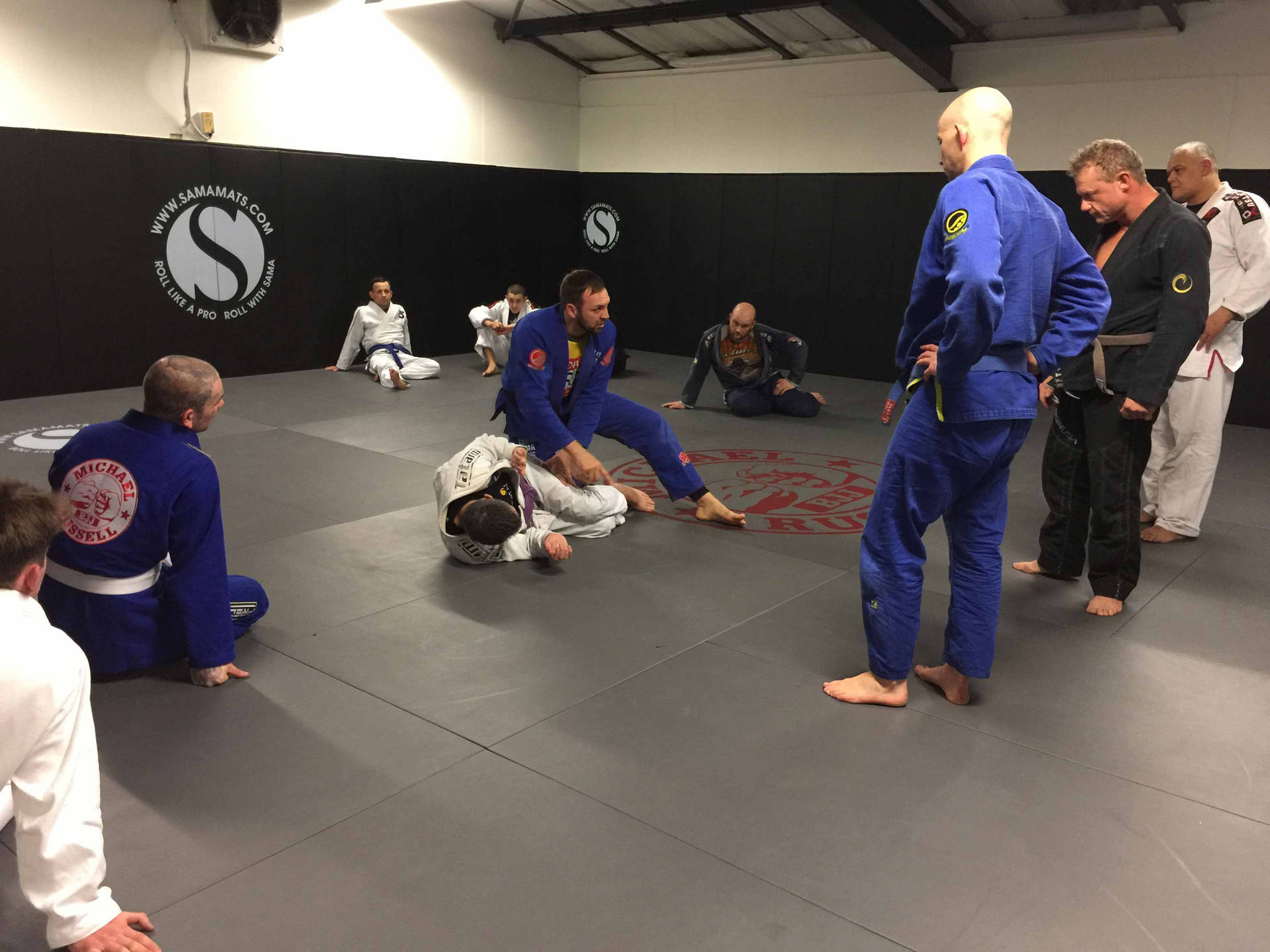 Thrill Of A Challenge - Engaging In Brazilian Jiu-jitsu In A Modern Studio Background