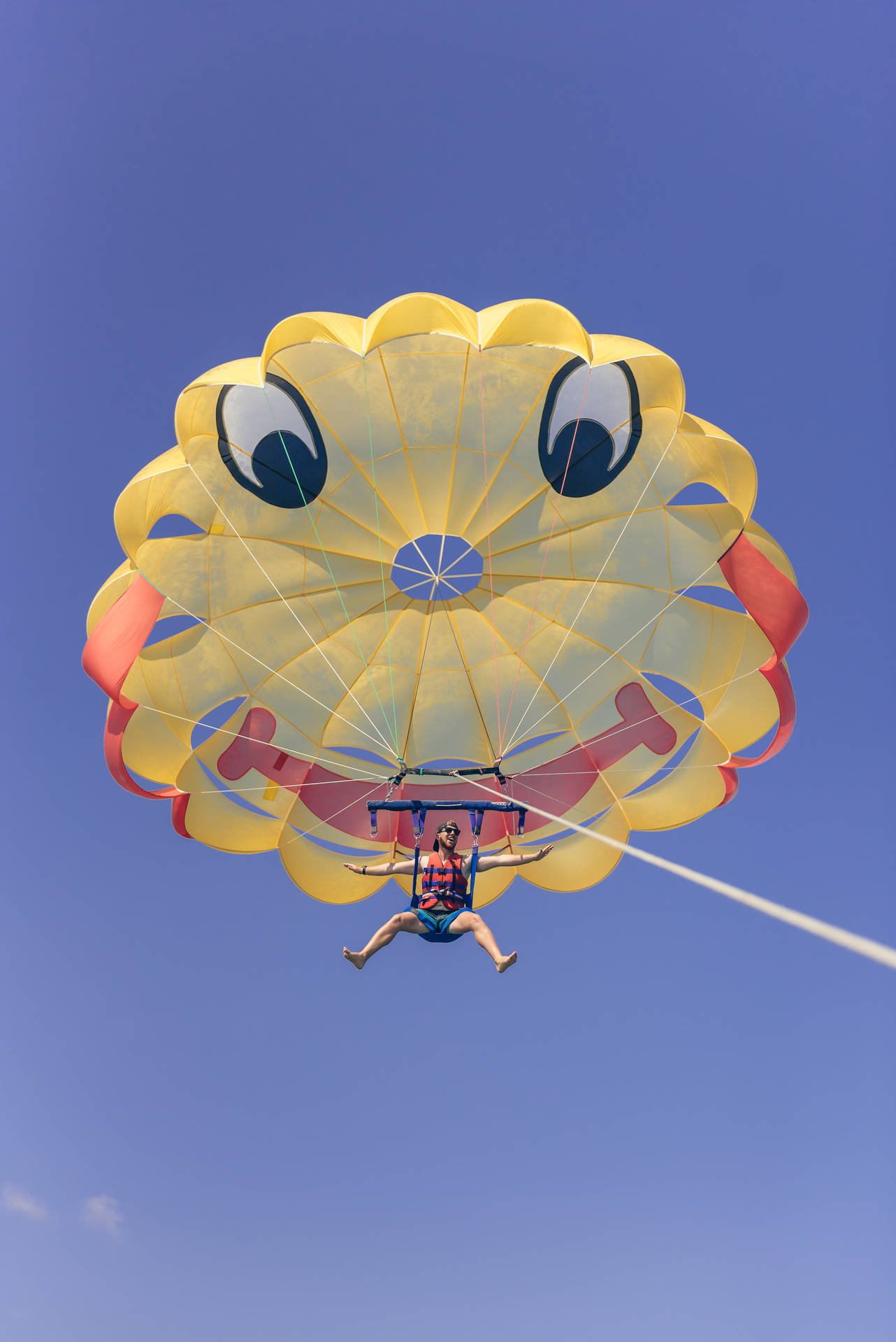 Thrilling Adventure With Smiley Face Parasailing Background