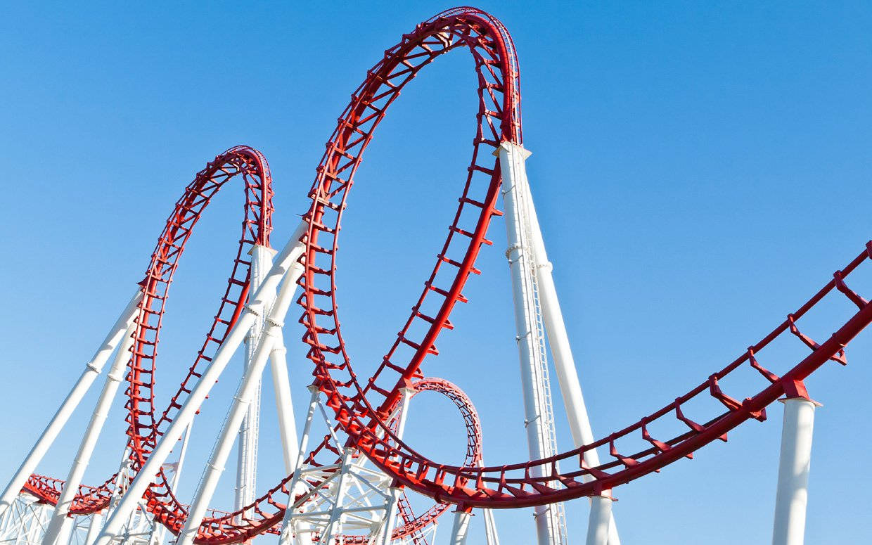 Thrilling Double Loop Roller Coaster Ride Background