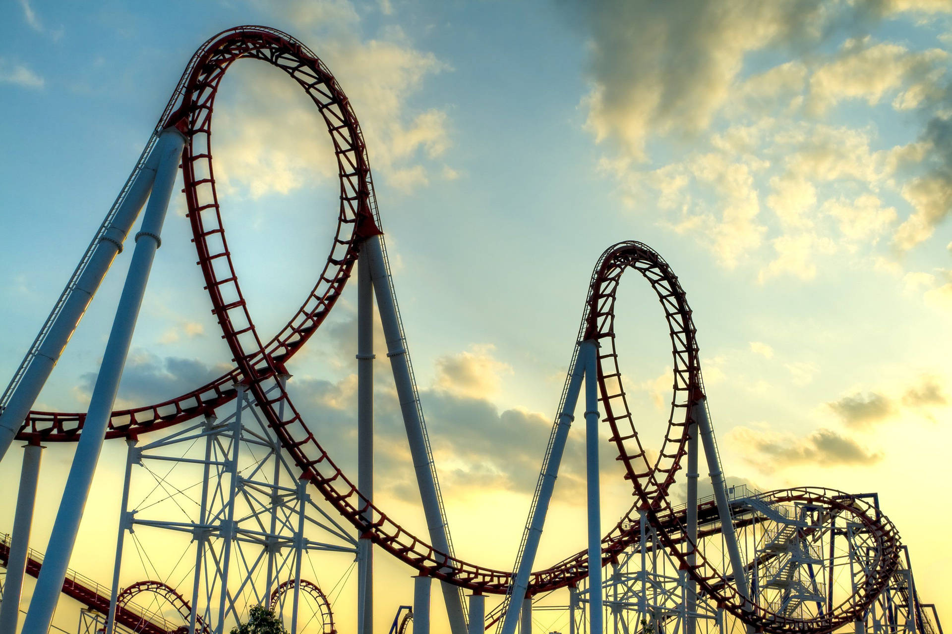 Thrilling Double Looped Roller Coaster Ride Background