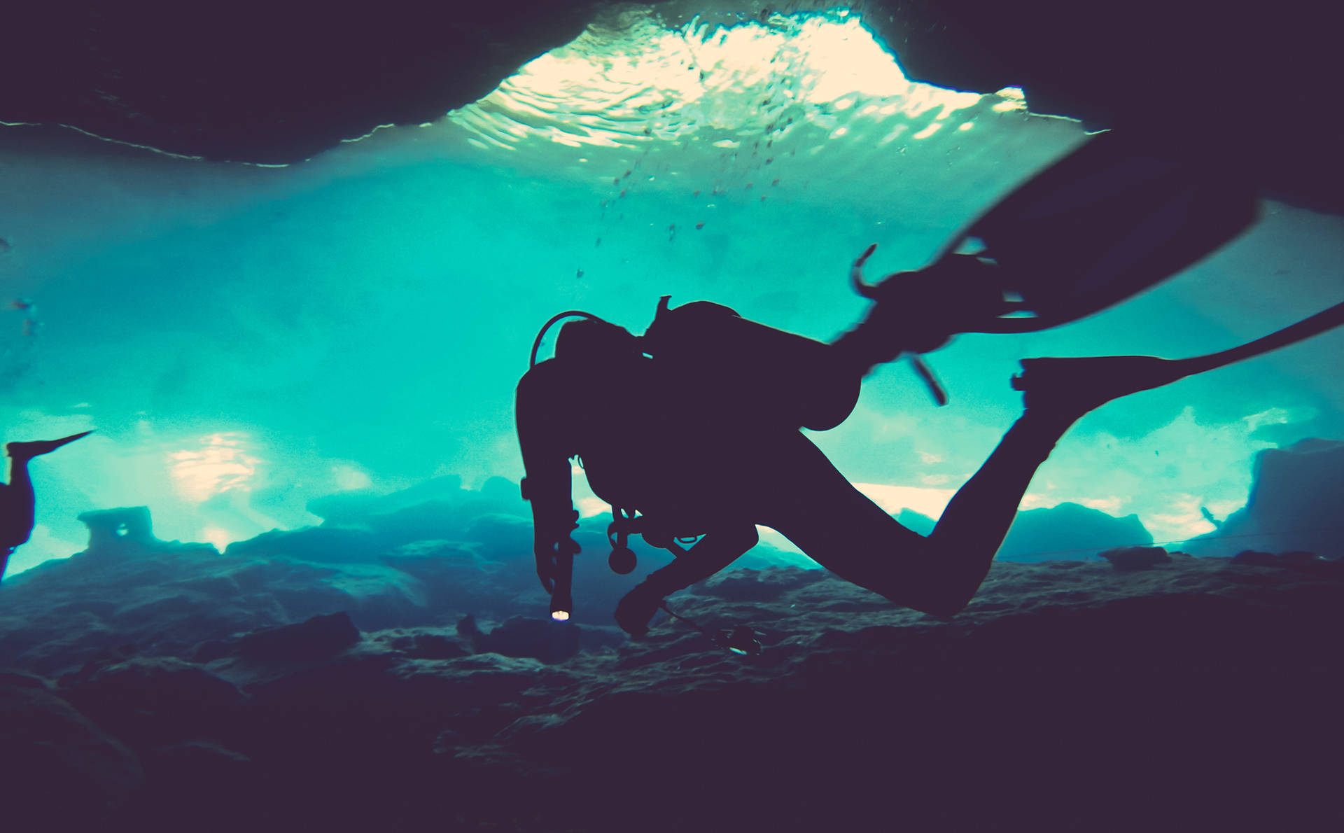 Thrilling Exploration: Scuba Diver In Underwater Cave Background