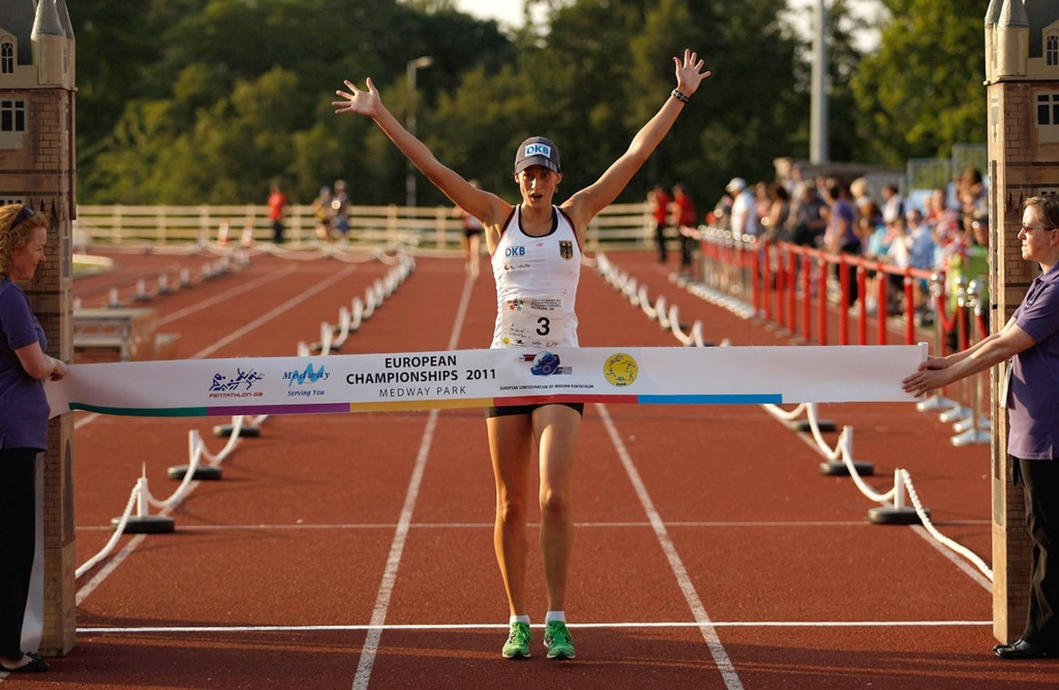 Thrilling Finish Line Snapshot From A Modern Pentathlon Event Background