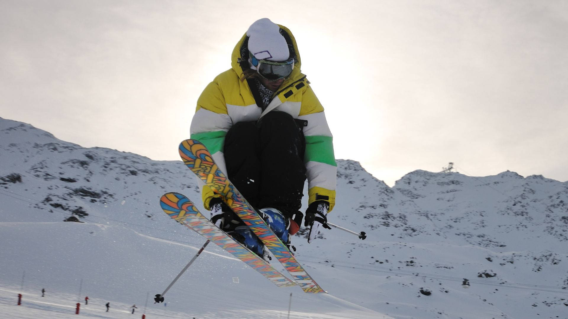 Thrilling Moment Of A Ski Jumper In Mid-flight At A Competitive Ski Jumping Event Background