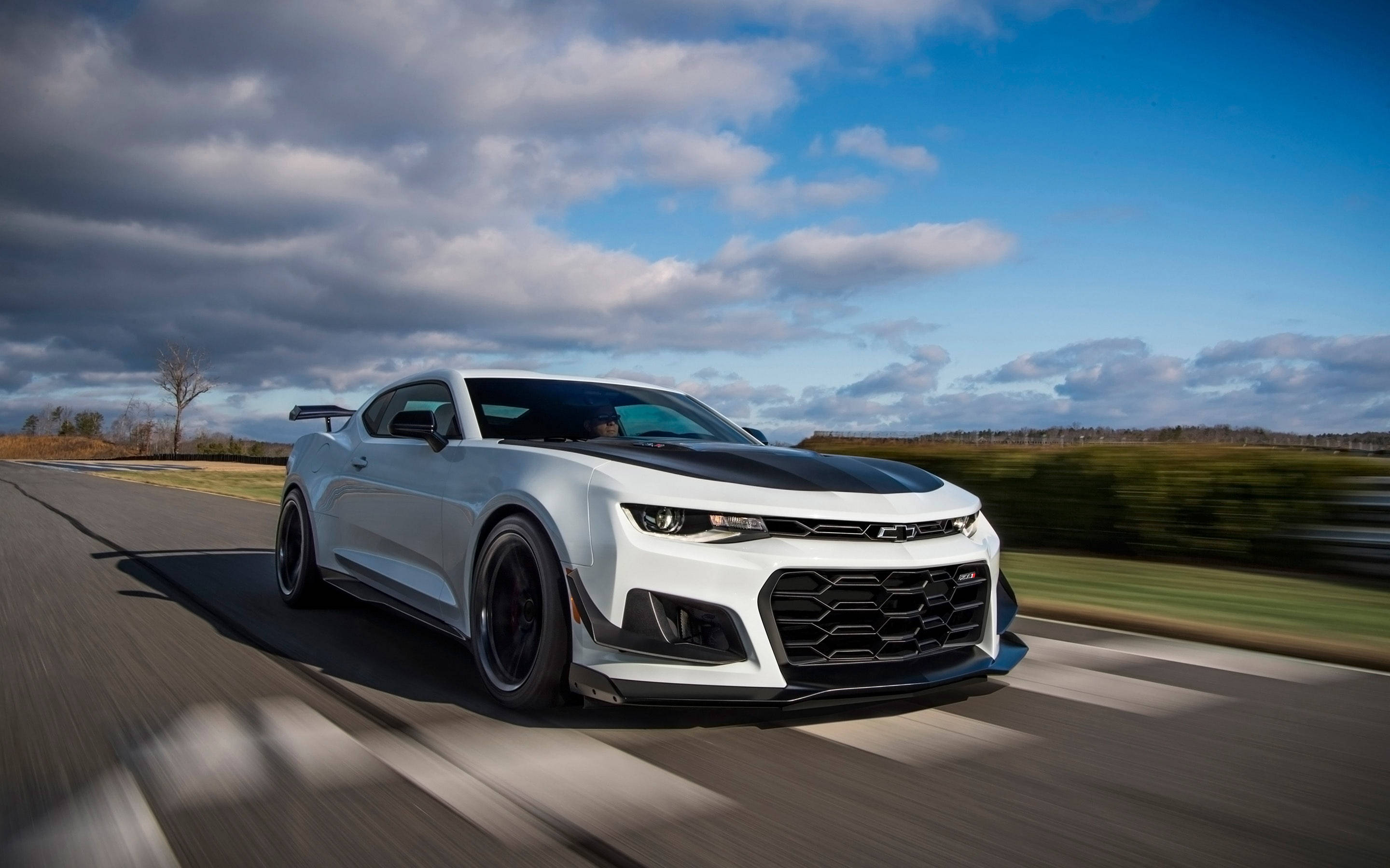 Thrilling Speed - White Camaro Muscle Car In A Drag Race Background