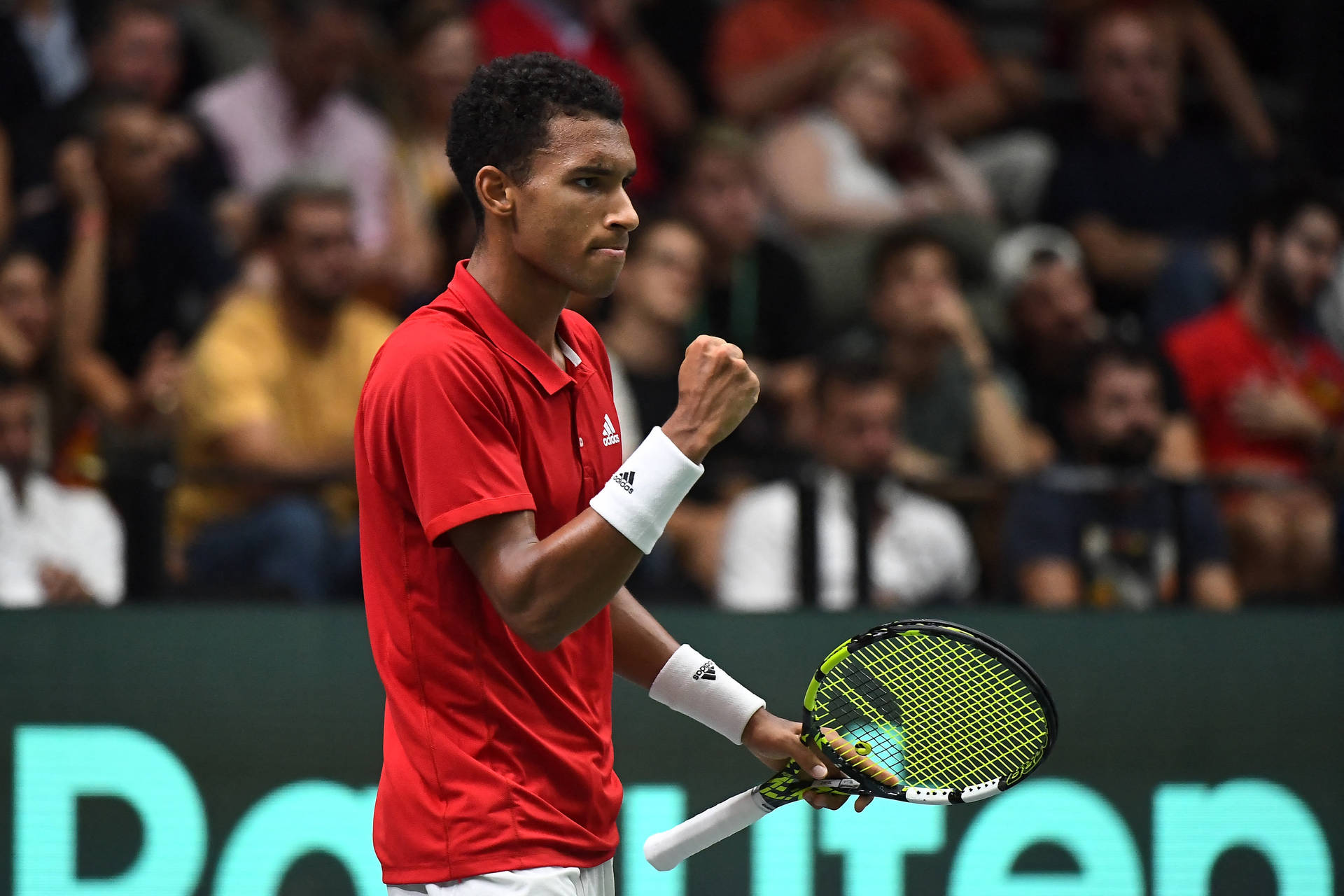 Thrilling Victory: Felix Auger Aliassime's Celebratory Fist Pump Background