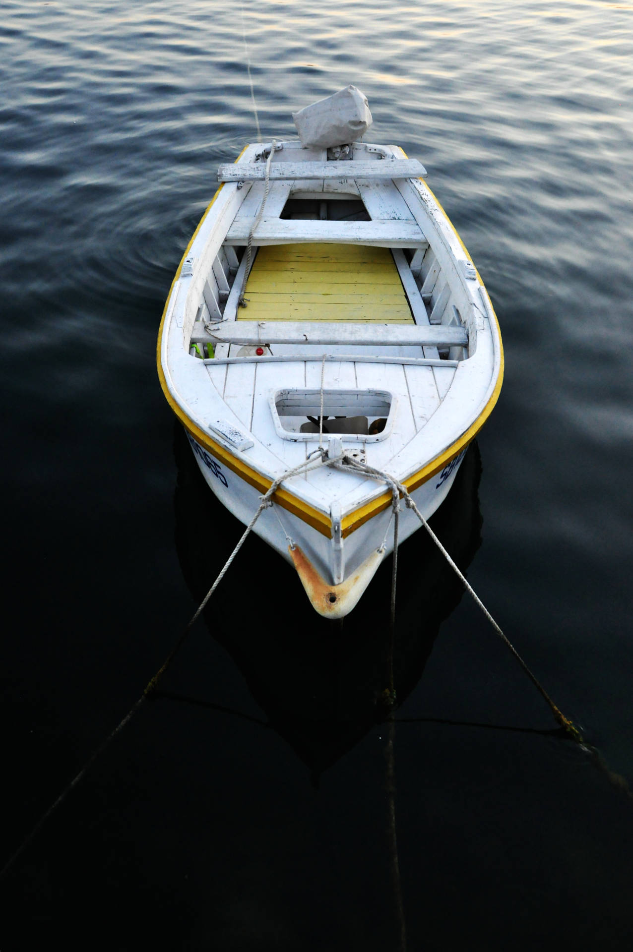 Tied Boat On Dark Water Background