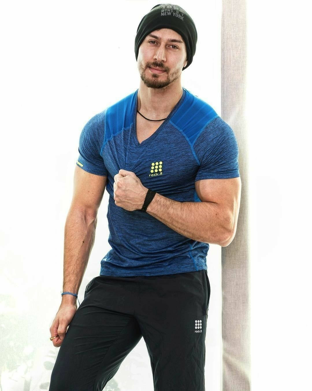 Tiger Shroff Flaunts His Chiseled Physique In A Blue Shirt Background