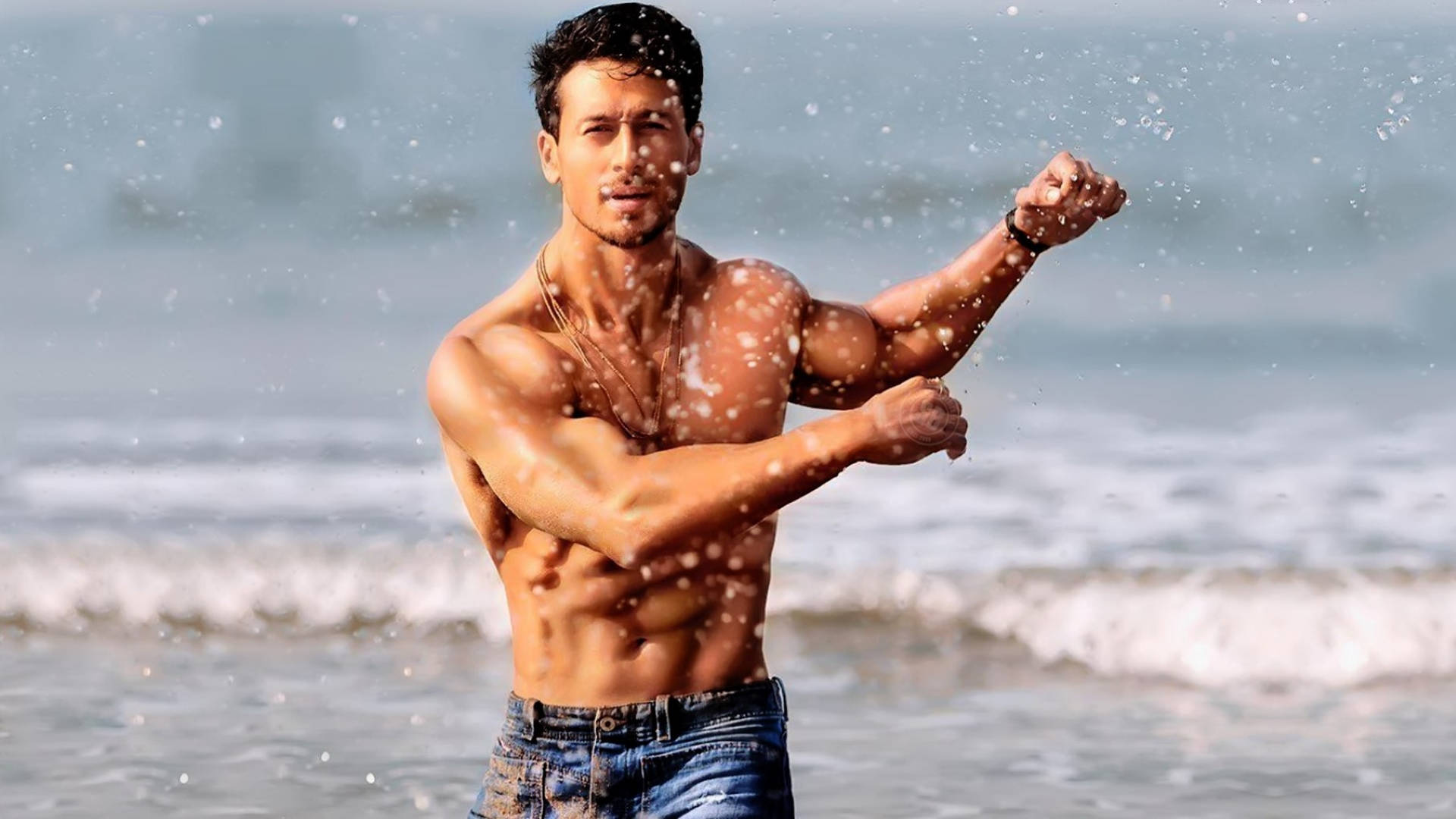 Tiger Shroff's Body At The Beach Background