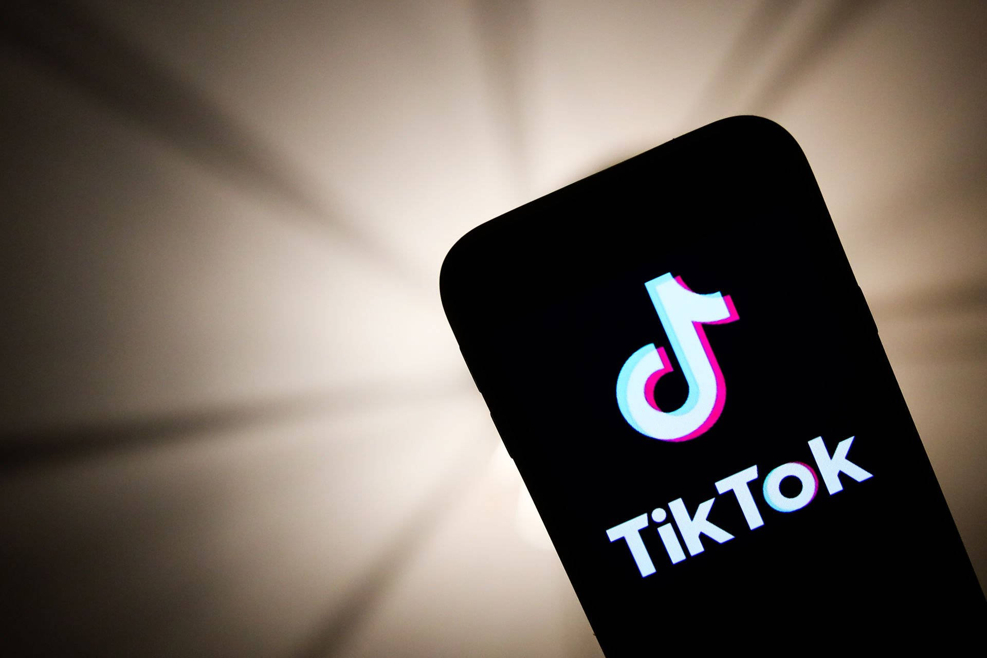 Tiktok Logo Displayed At Phone Screen Background