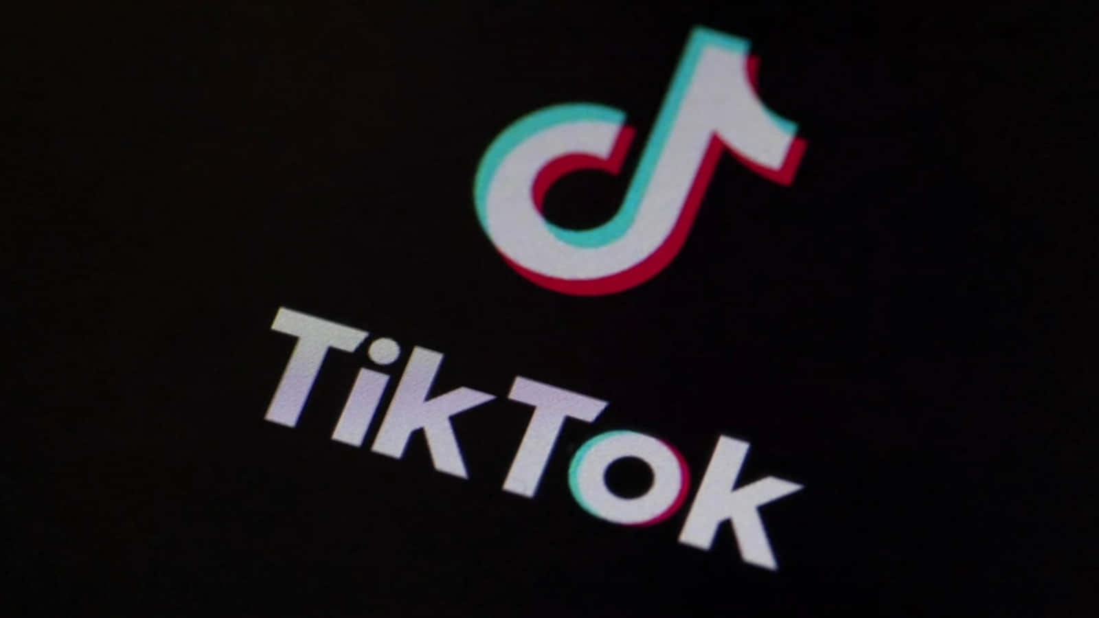 Tiktok Logo Is Seen On A Black Screen Background