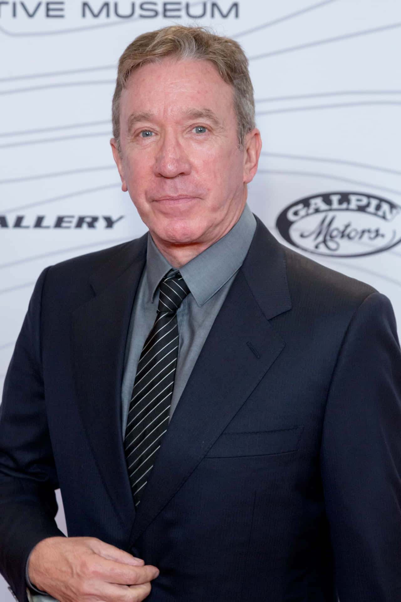 Tim Allen Expresses His Warm Smile On The Red Carpet Background