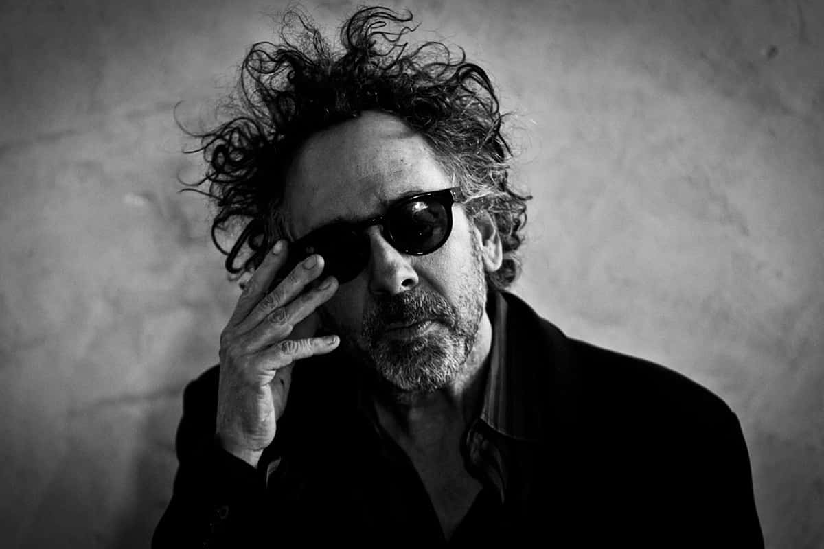 Tim Burton Poses For A Photo Background