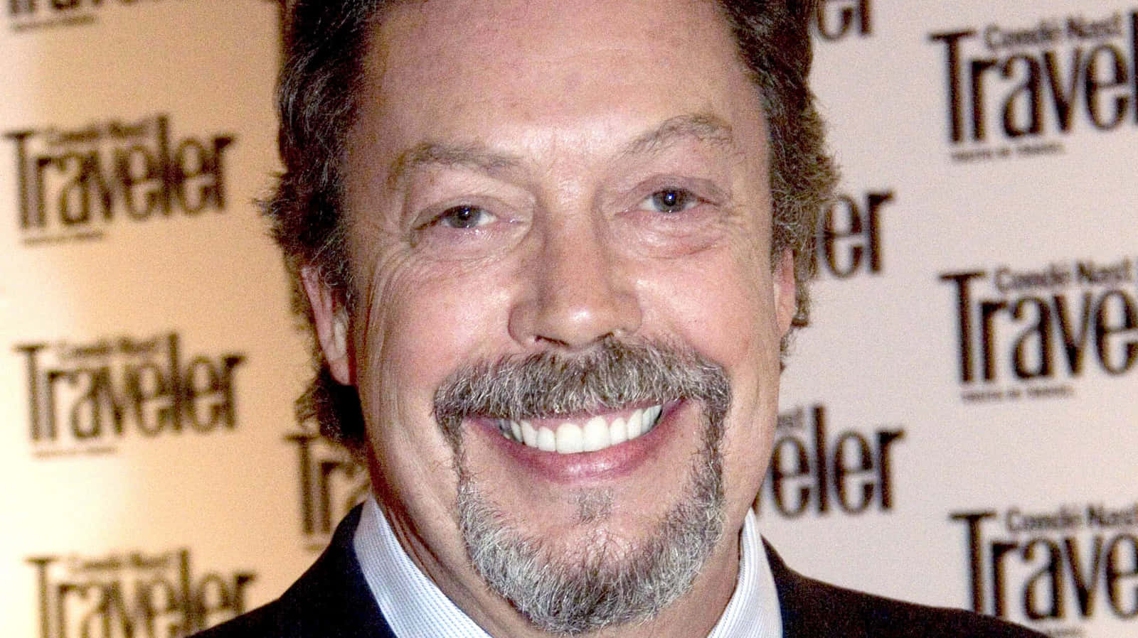 Tim Curry, Iconic British Actor, In A Captivating Portrait Background