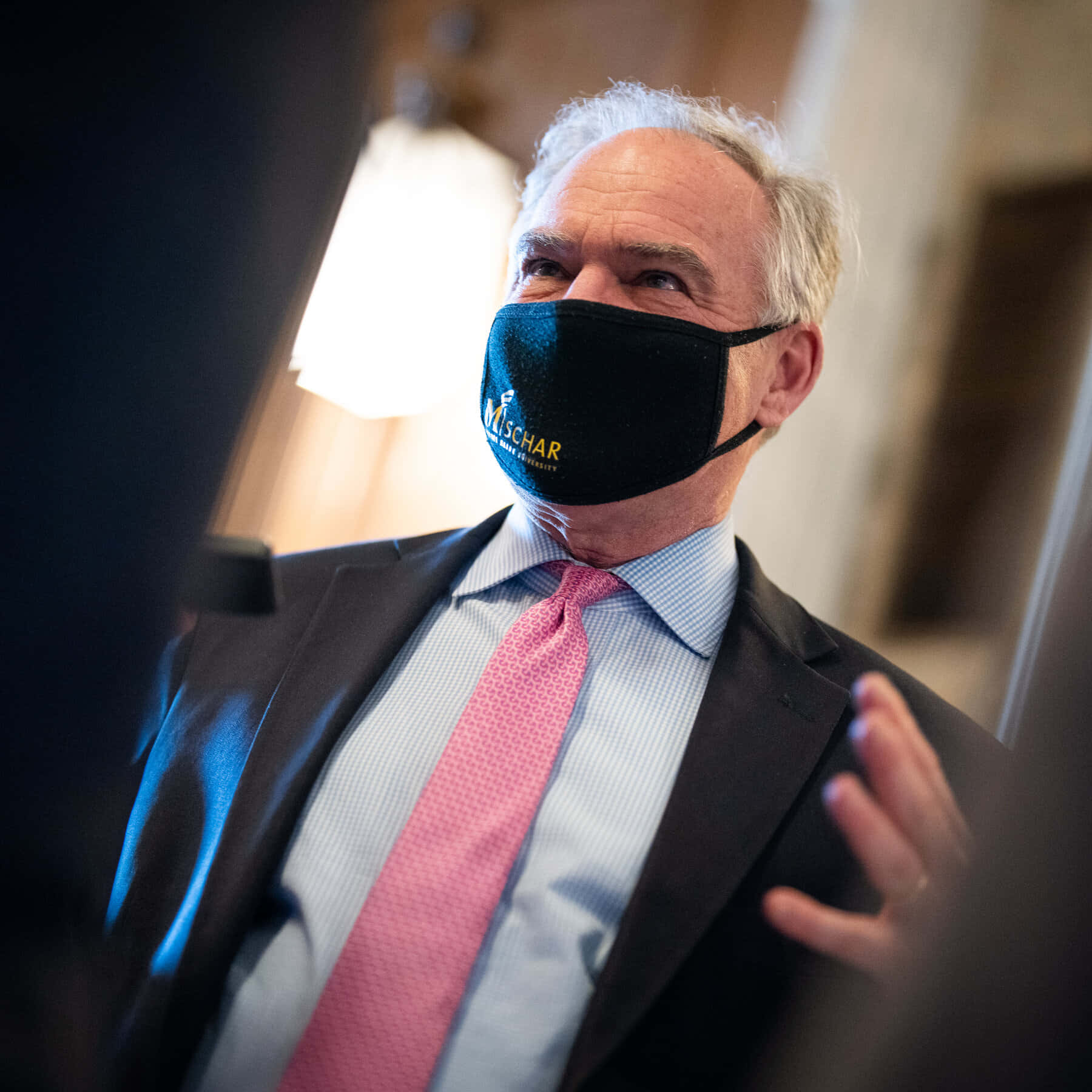 Tim Kaine Wearing A Black Face Mask Background