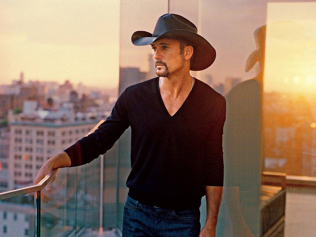 Tim Mcgraw On Glass Building Background