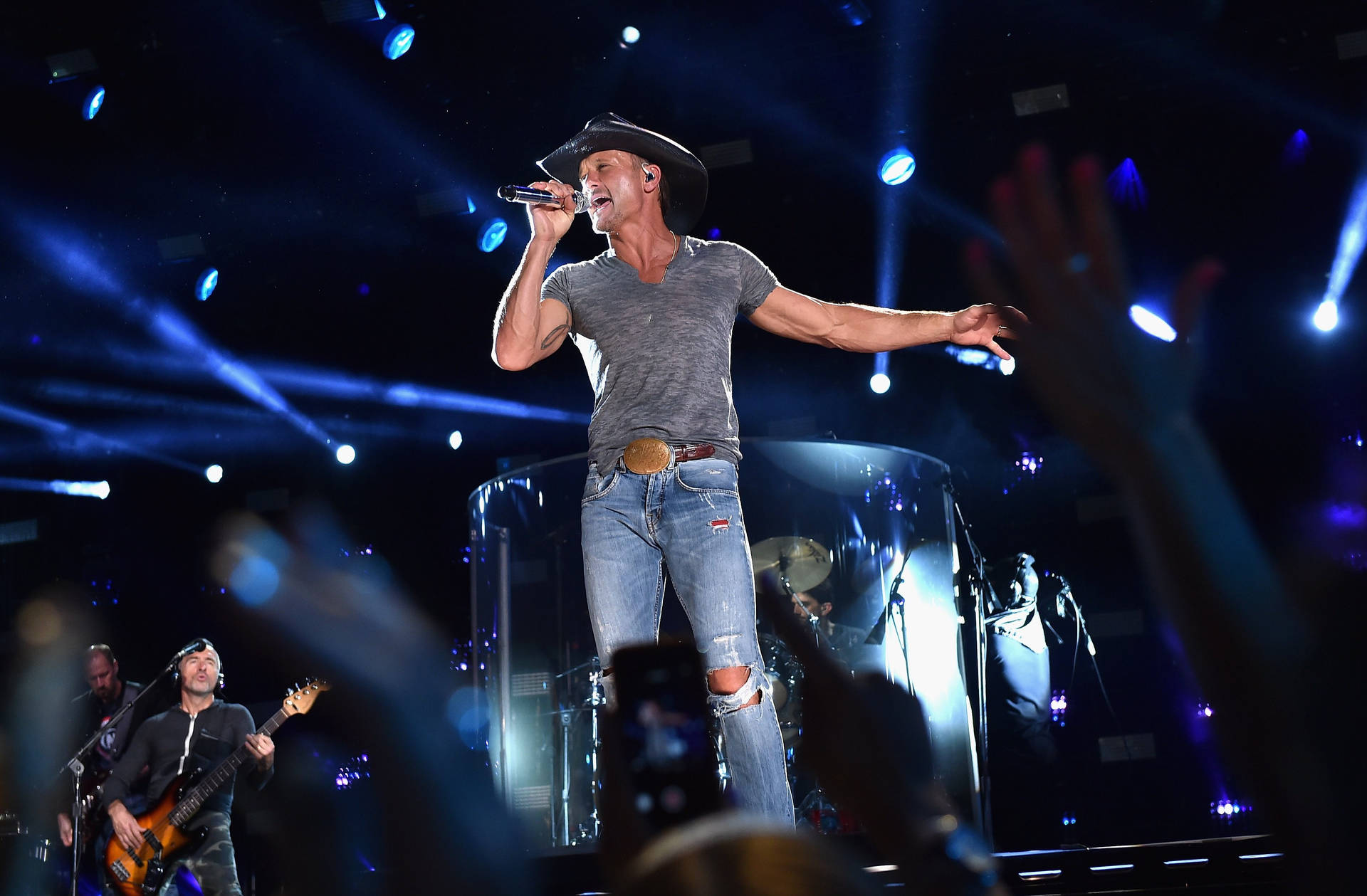 Tim Mcgraw Performing On Stage Background