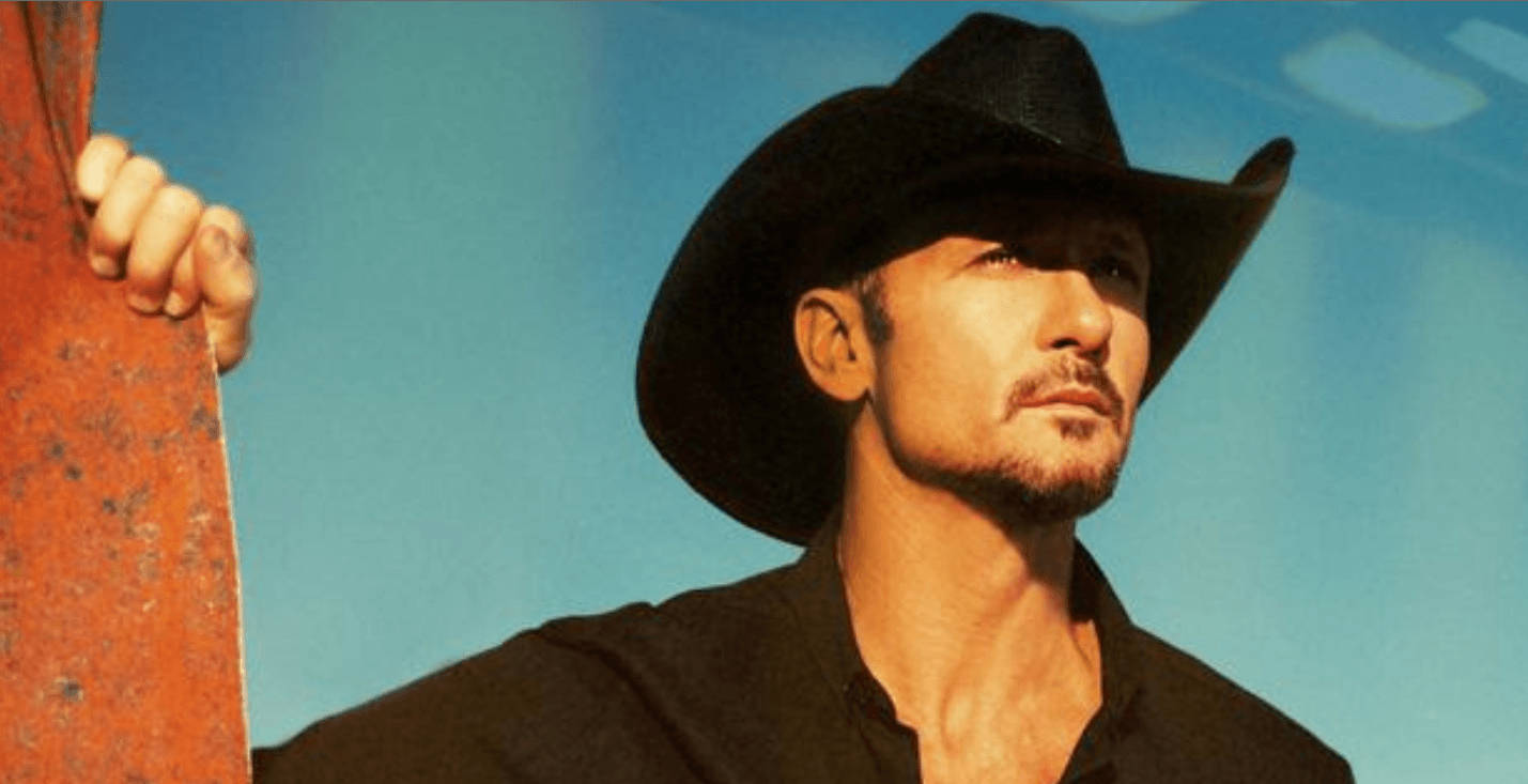 Tim Mcgraw With Blue Sky Background Background