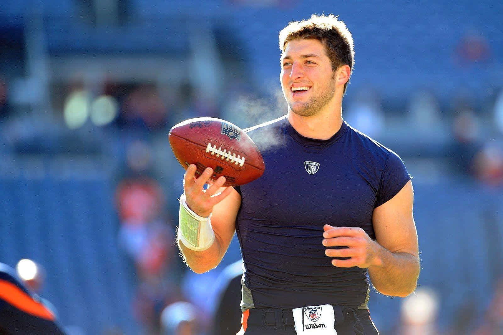 Tim Tebow Embracing A Crowd Of Supporters Background