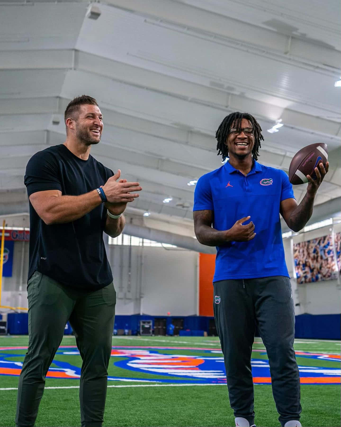 Tim Tebow Making A Yard At An Nfl Game. Background