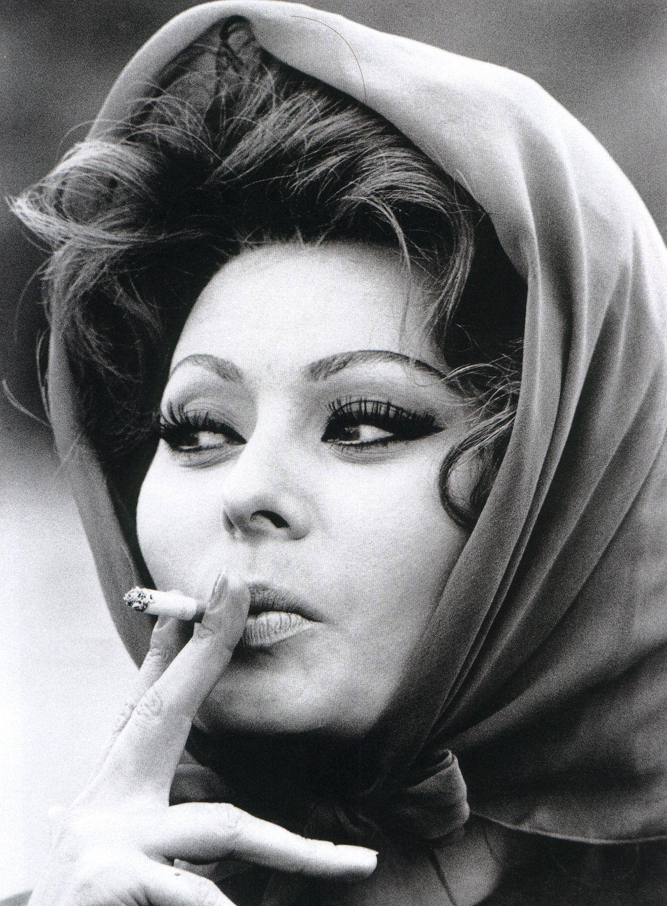 Timeless Elegance: Sophia Loren Smoking On Set Background