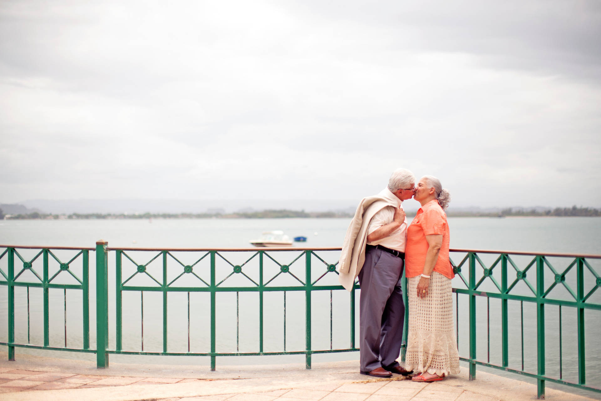 Timeless Love: An Elderly Couple In A Romantic Embrace Background
