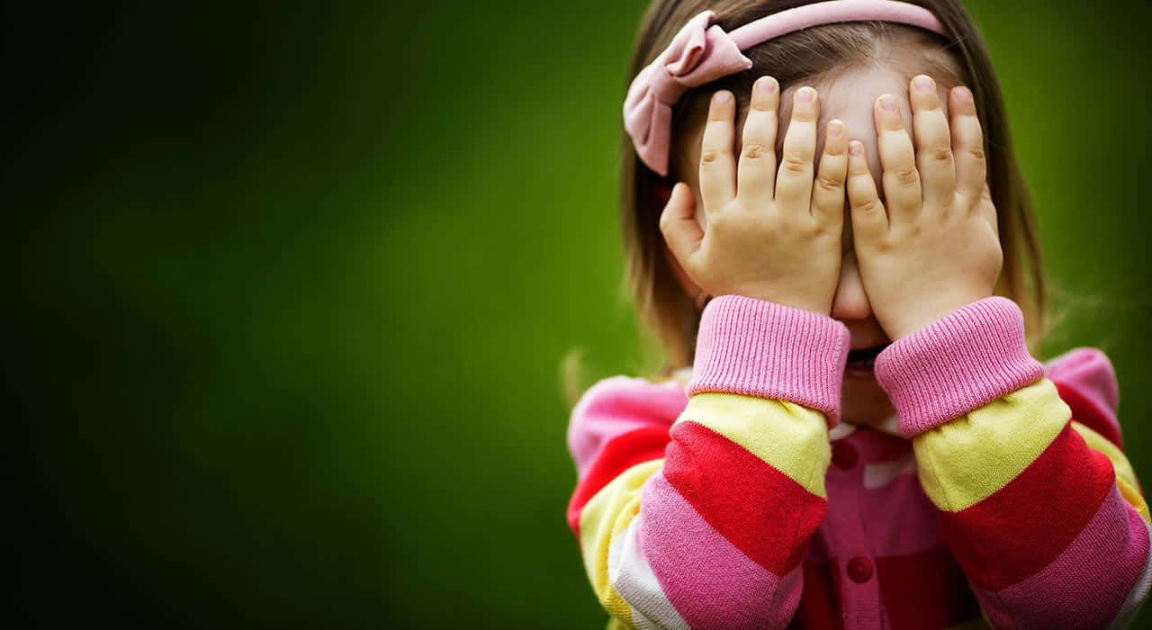 Timid Child Covering Face