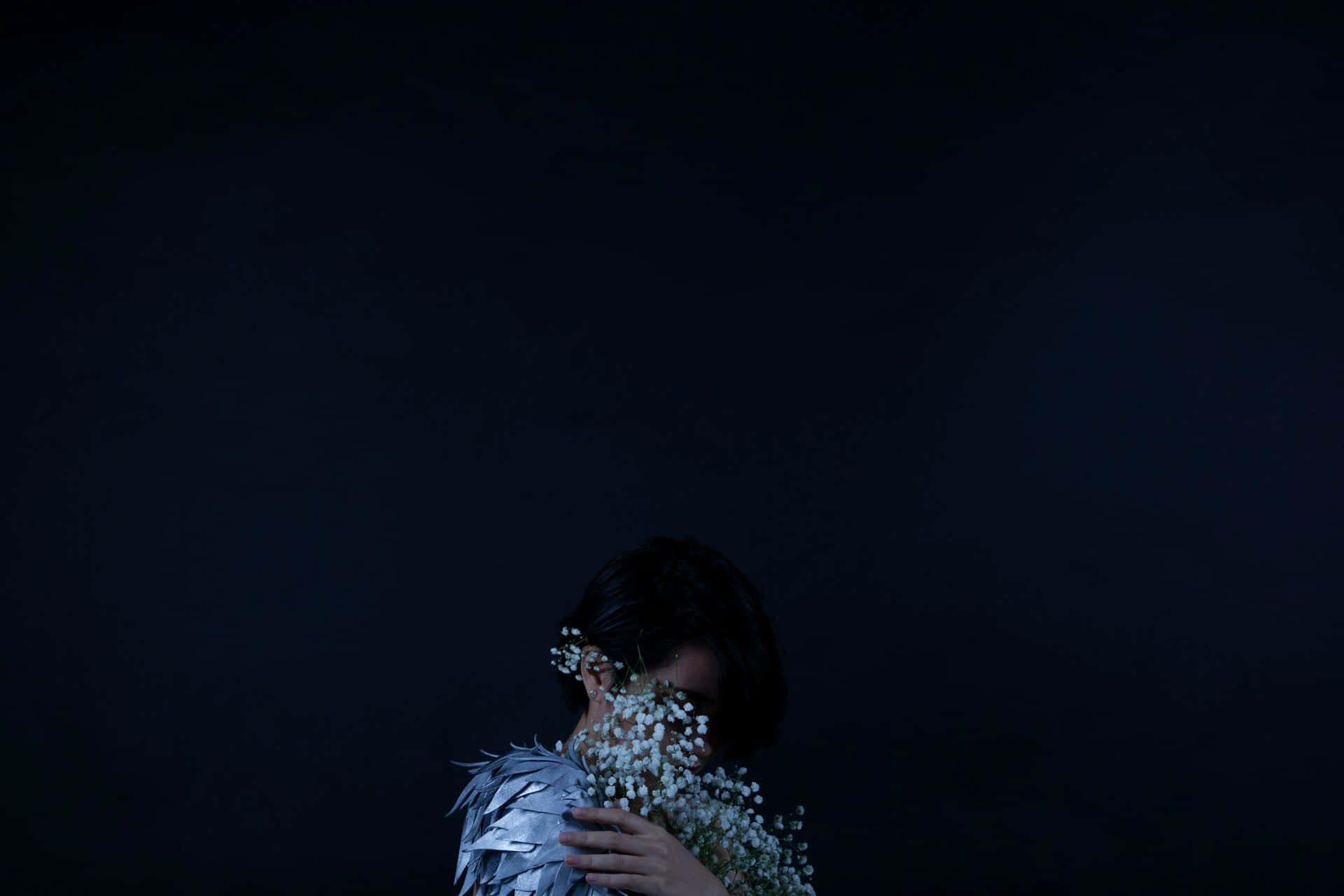 Timid Person Holding Flowers Dark Background Background