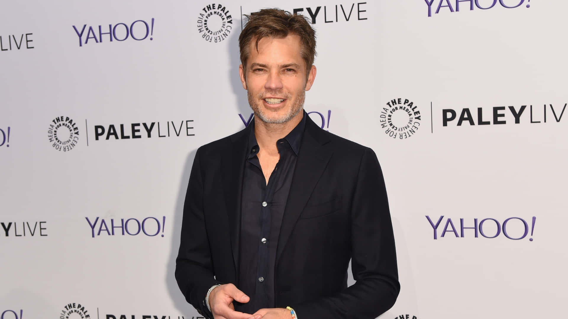 Timothy Olyphant Striking A Pose For A Photoshoot Background