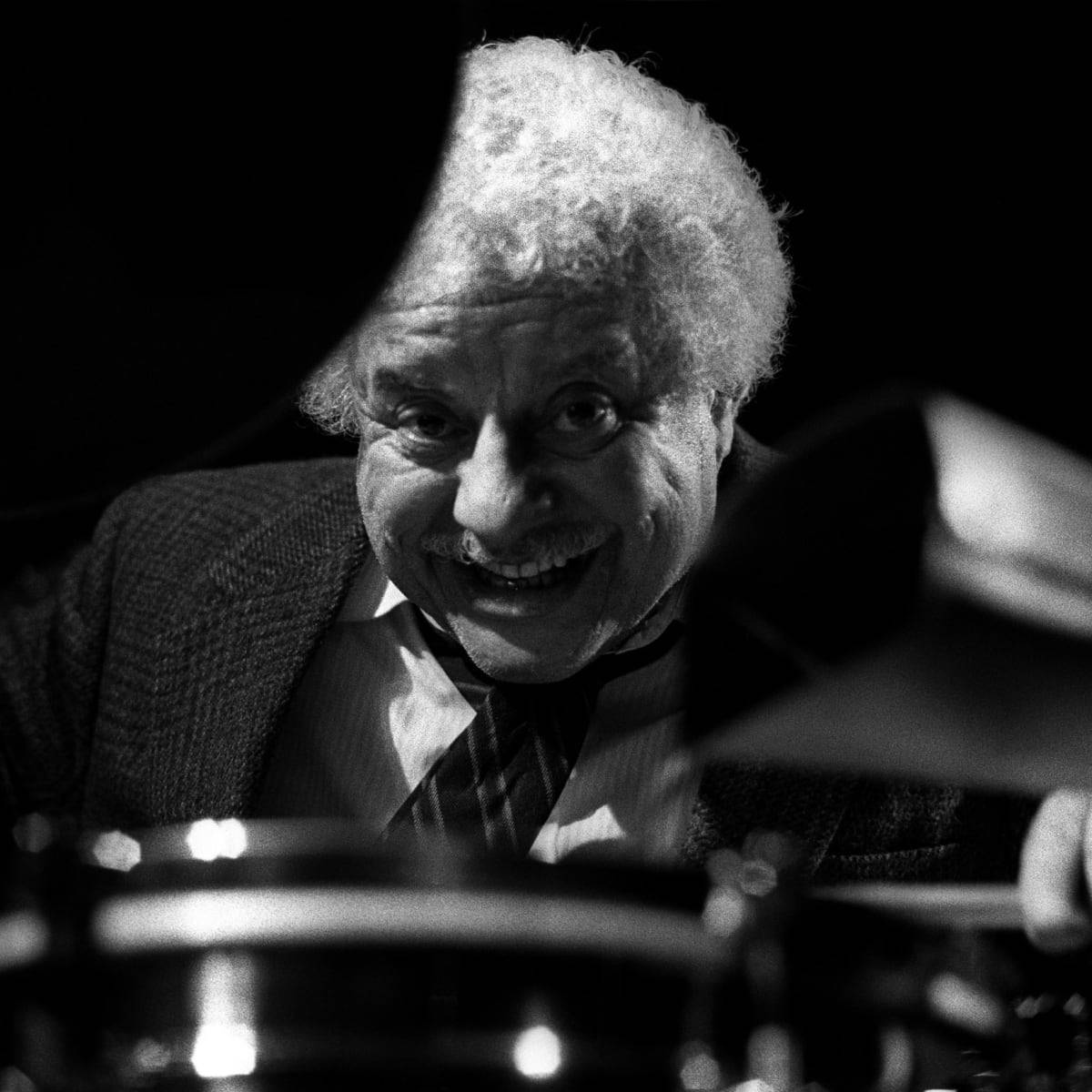 Tito Puente Beaming Smile Background