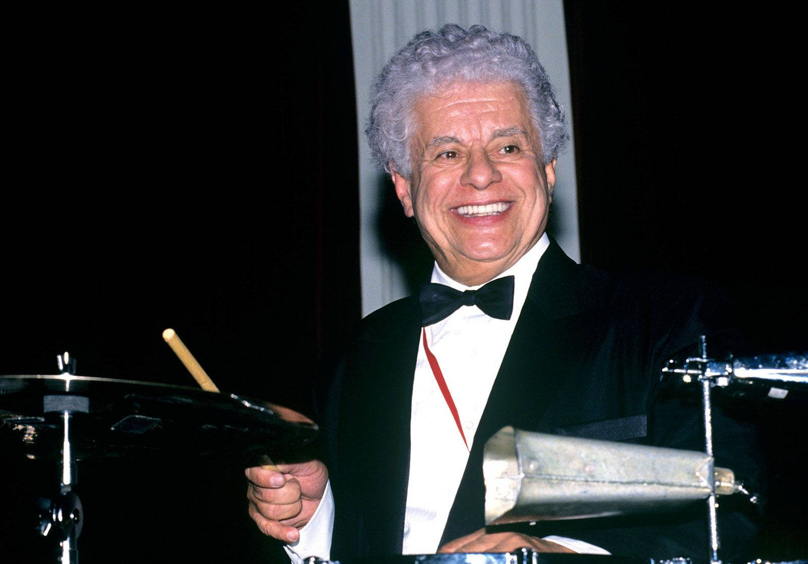 Tito Puente Smiling While Drumming Background