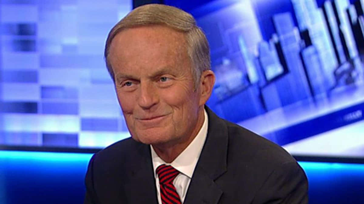 Todd Akin Standing Against A Building Background