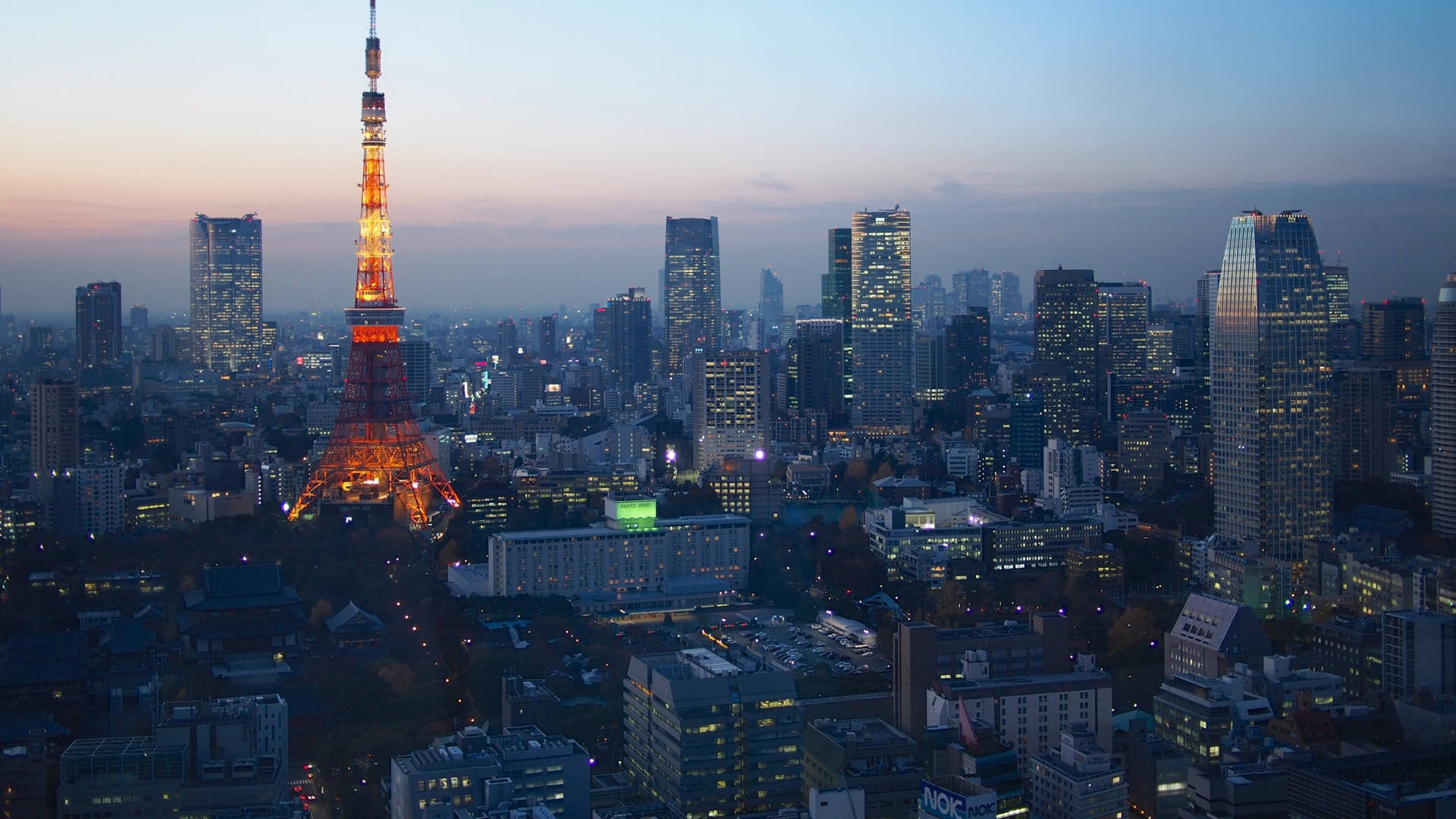 Tokyo Tower Illuminating The Night Sky Background