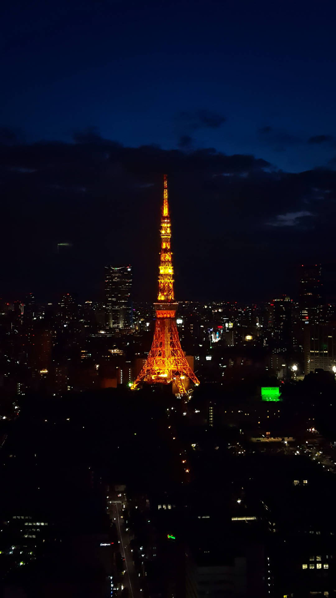 Tokyo Tower Lighting Up Dark City Background