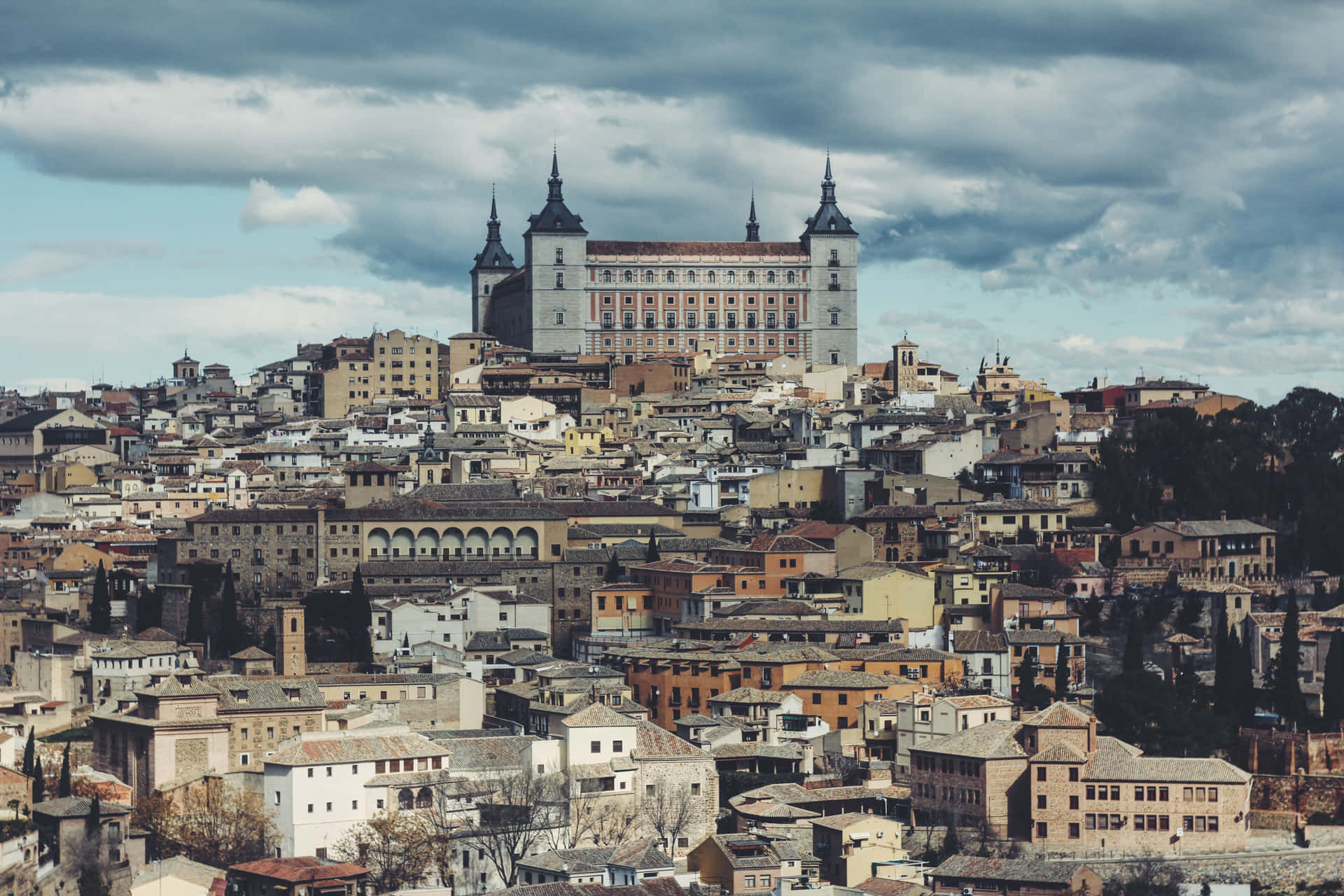 Toledo Cathedral Beneath The Cloudy Sky Background