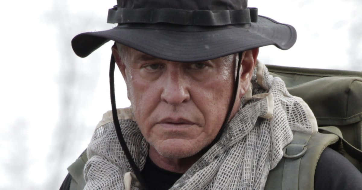 Tom Berenger Looking Focused In A Close-up Shot Background