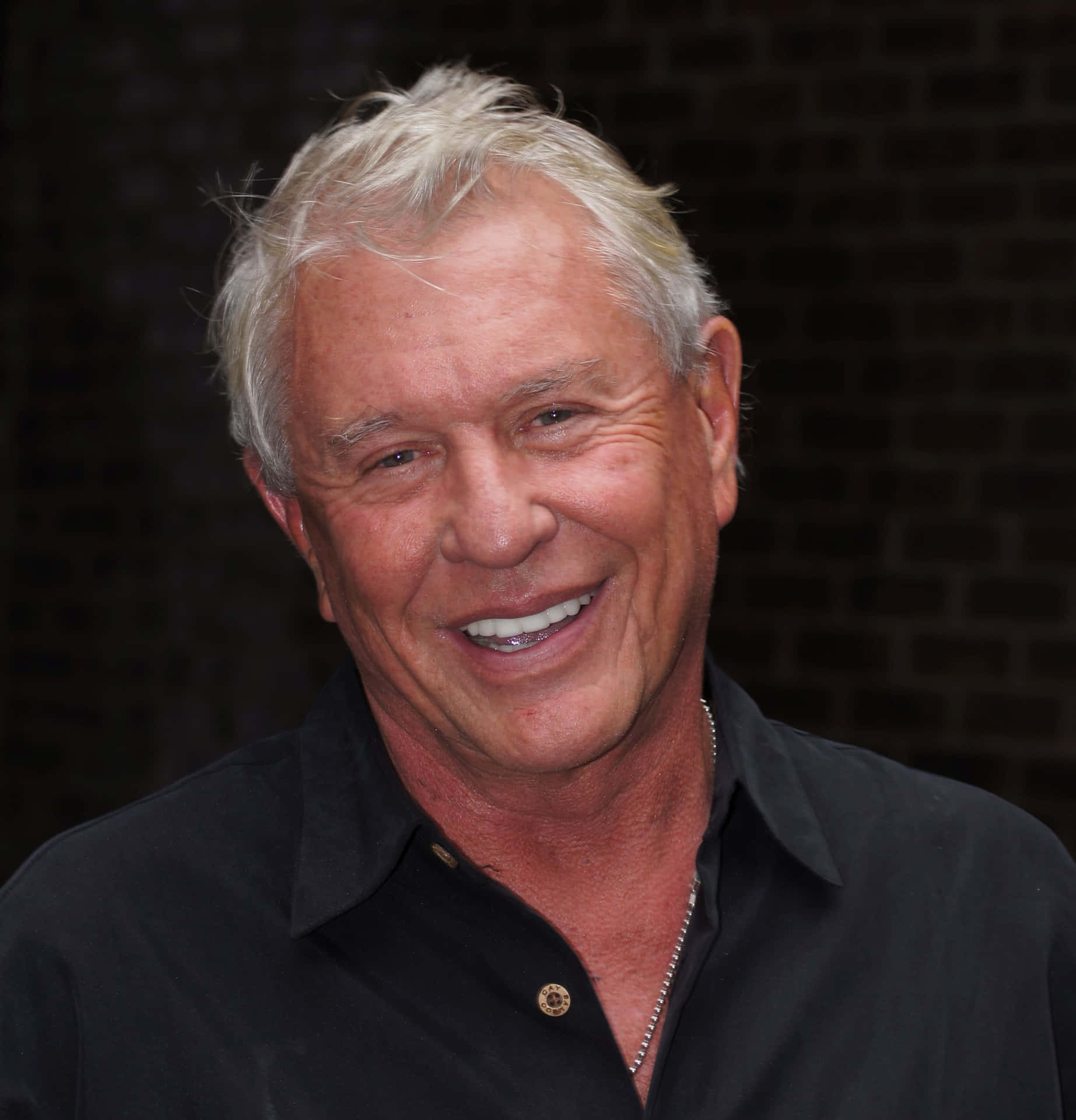 Tom Berenger Posing For A Photoshoot Background