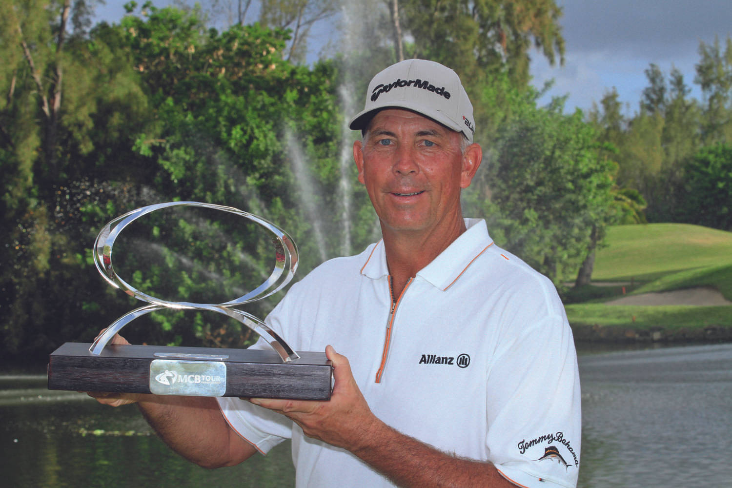 Tom Lehman Carrying A Spherical Trophy Background