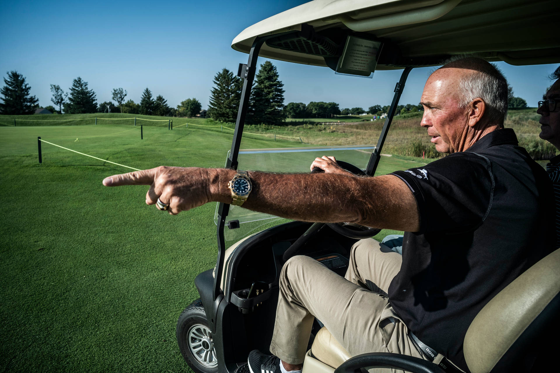 Tom Lehman Driving A Golf Cart Background